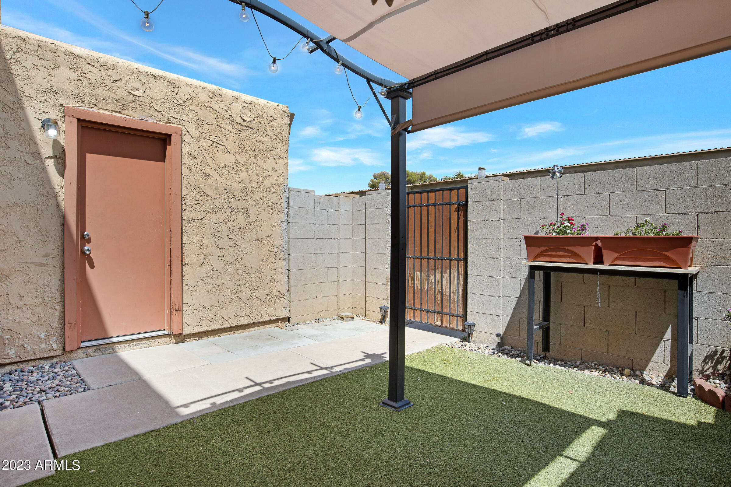 948 South Alma School Road, Unit 147 Mesa, AZ 85210 - Photo 5 of 22 a view of a patio with table and chairs