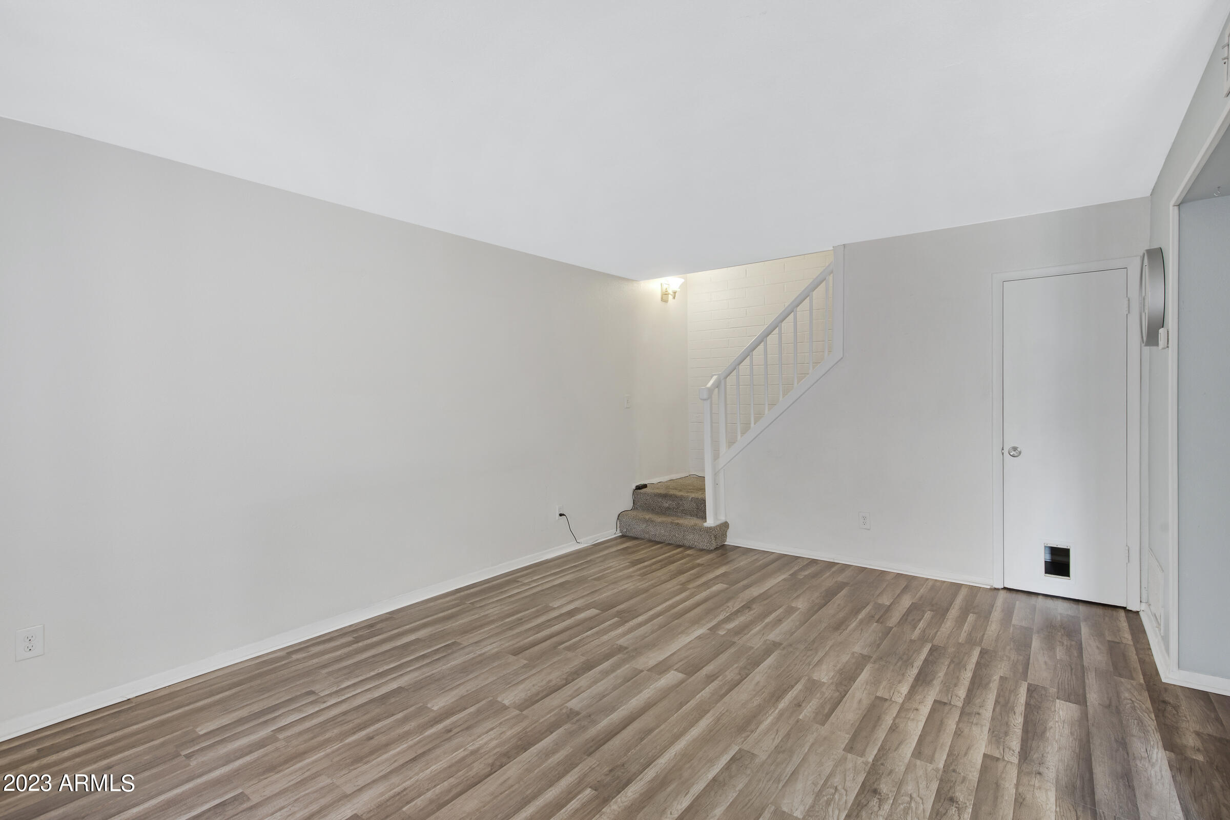 948 South Alma School Road, Unit 147 Mesa, AZ 85210 - Photo 6 of 22 a view of empty room with wooden floor