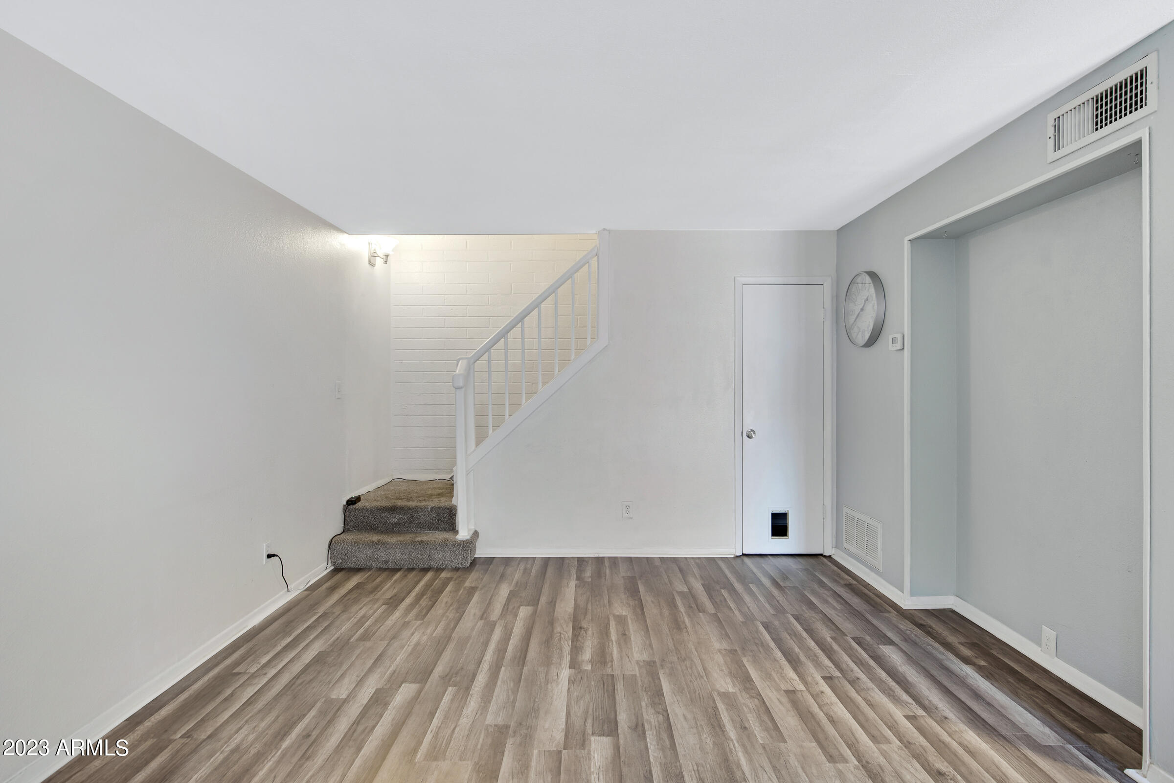 948 South Alma School Road, Unit 147 Mesa, AZ 85210 - Photo 8 of 22 a view of empty room with wooden floor