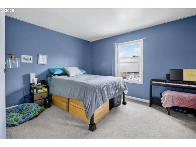 a bedroom with a bed table and a window