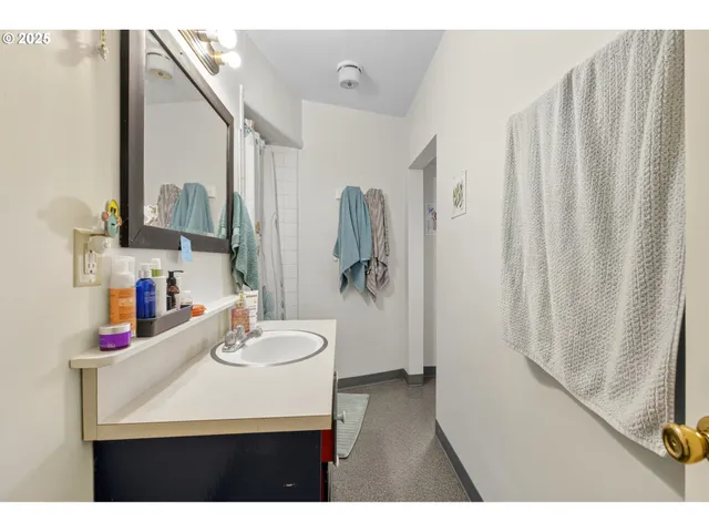 a bathroom with a sink vanity and a mirror