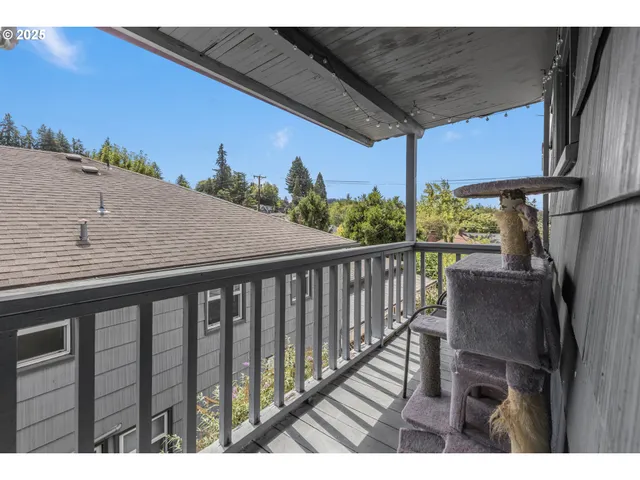 a balcony with wooden floor and outdoor seating