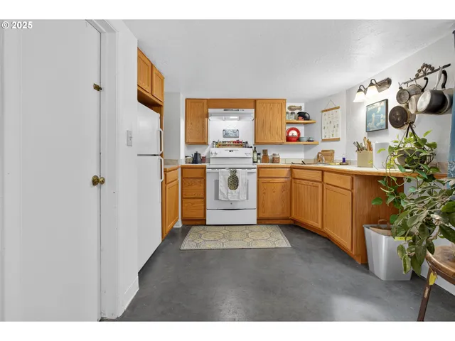 a kitchen with a sink stove and refrigerator