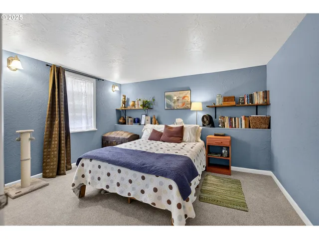 a bedroom with a bed and a book shelf