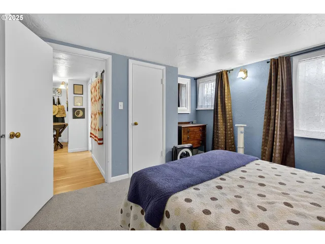 a bedroom with a large bed and a dresser