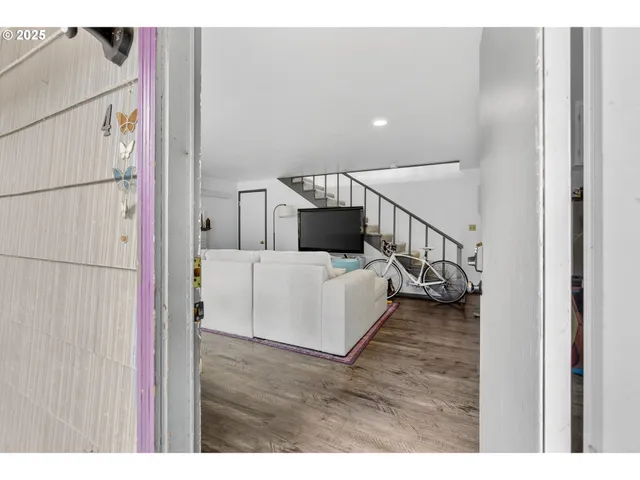 a view of a livingroom with furniture and stairs