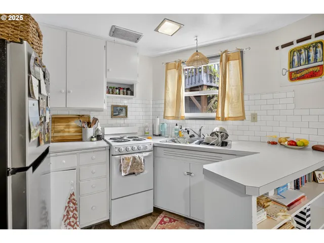 a kitchen with a sink stove and cabinets