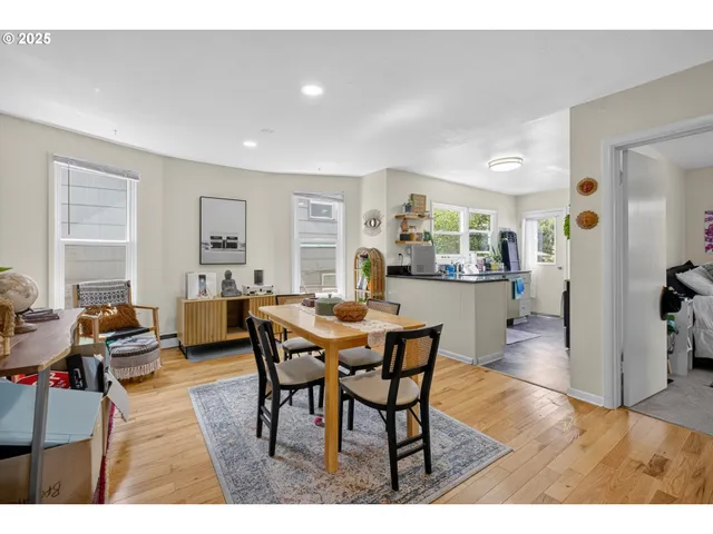 a view of a dining room with furniture and wooden floor