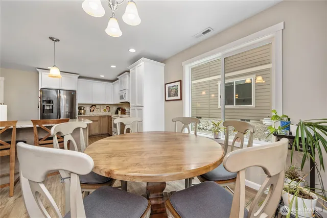 a living room with furniture kitchen view and a large window