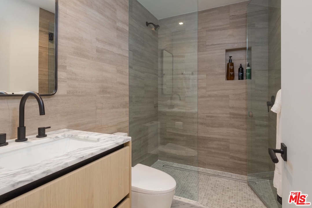 629 Sunset Avenue Venice, CA 90291 - Photo 26 of 31 a bathroom with a granite countertop sink a toilet and shower