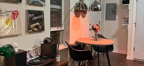 a dining room with furniture and wooden floor