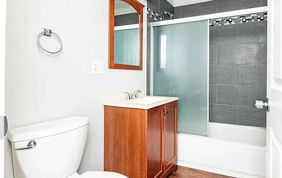 a bathroom with a sink toilet and shower