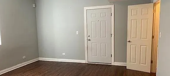 an empty room with wooden floor