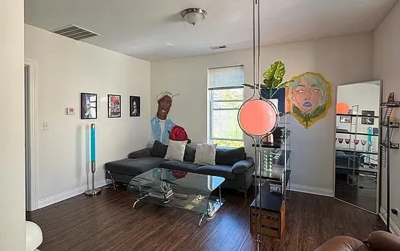 a living room with furniture and a mirror