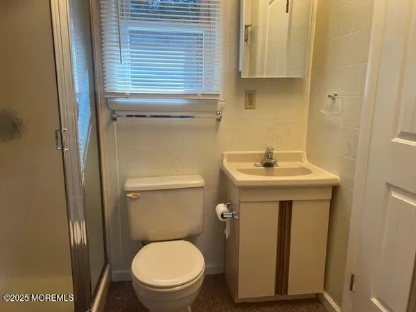 a bathroom with a sink toilet and a mirror