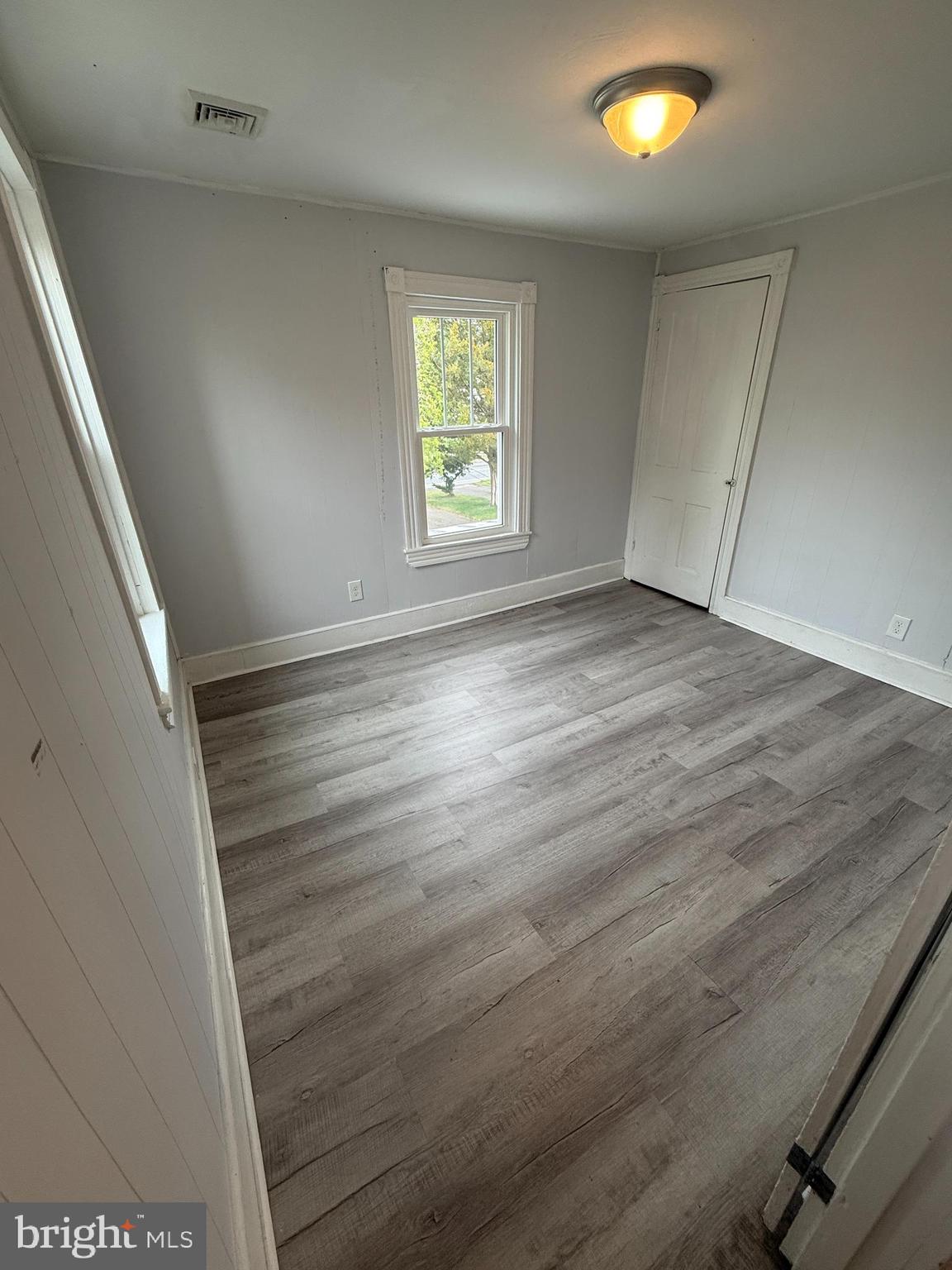 1036 South Spring Road Vineland, NJ 08361 - Photo 24 of 31 an empty room with wooden floor and windows
