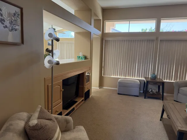 a living room with furniture a fireplace and a large window