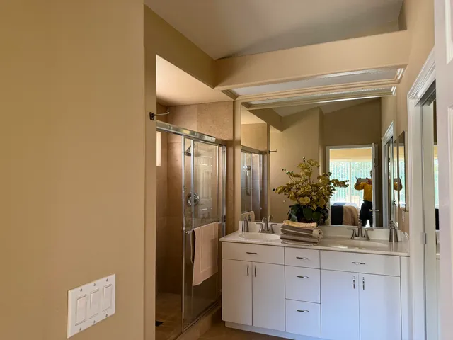 a bathroom with a double vanity sink and mirror