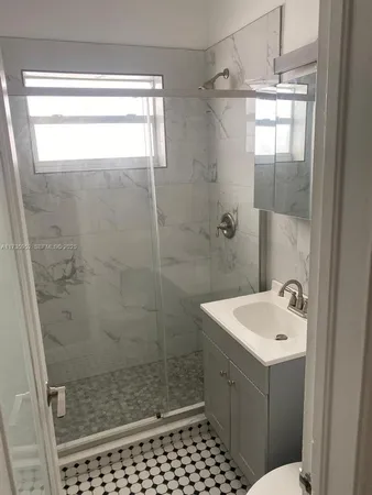 a bathroom with a shower a toilet and sink