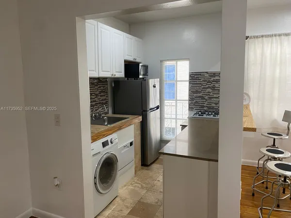 a view of kitchen sink washer and dryer