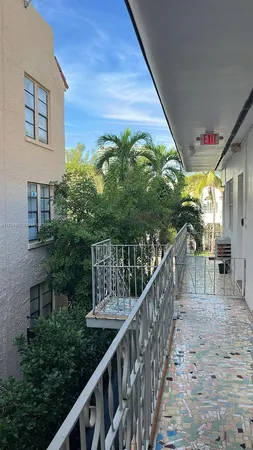 a view of balcony with wooden floor and fence