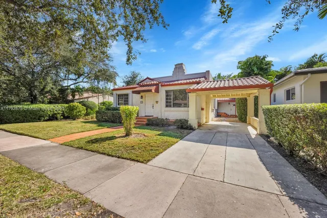 a front view of a house with yard and green space
