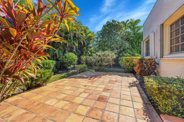 a view of backyard with plants and outdoor seating