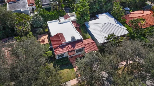 an aerial view of a house with a yard and lake view