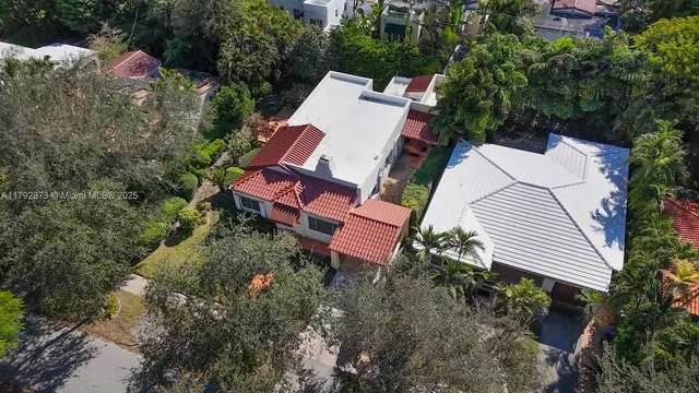 an aerial view of a house with a yard and trees