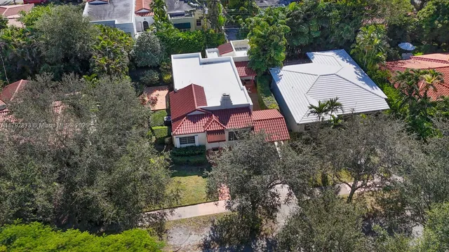 an aerial view of a house with a yard and lake view