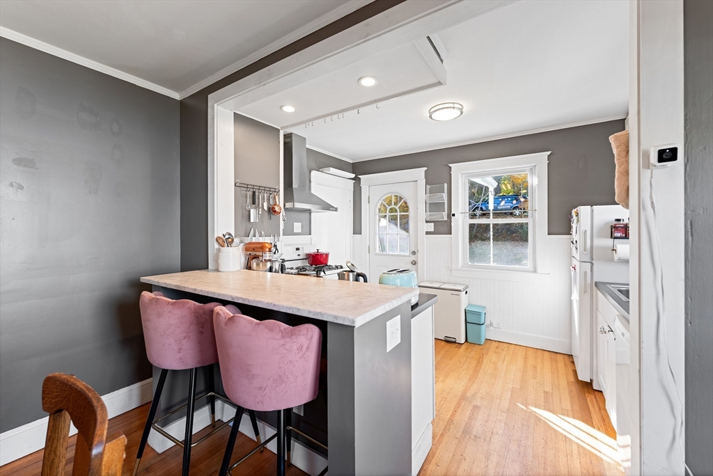 39 Catherine Street Pittsfield, MA 01201 - Photo 18 of 36 a view of a kitchen area with furniture and wooden floor