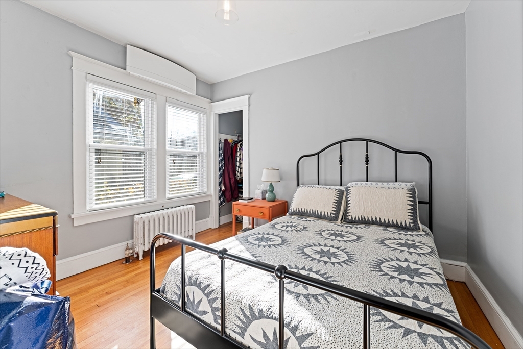 39 Catherine Street Pittsfield, MA 01201 - Photo 19 of 36 a bedroom with a bed and wooden floor