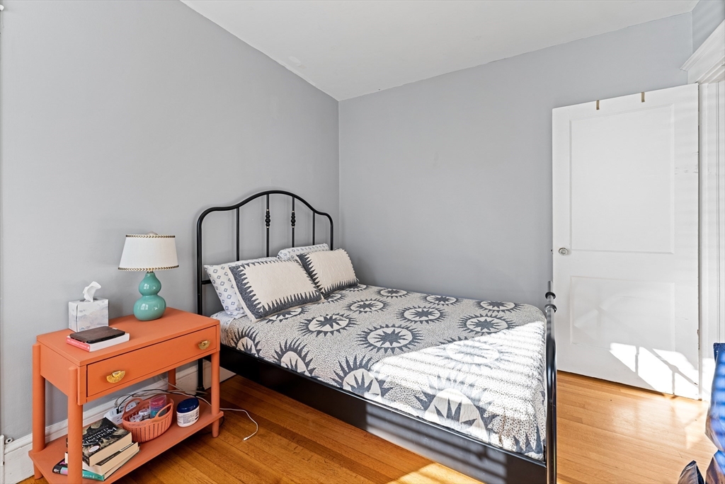39 Catherine Street Pittsfield, MA 01201 - Photo 20 of 36 a bedroom with a bed and a potted plant on dresser