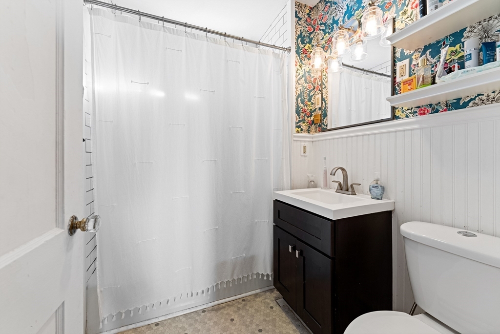 39 Catherine Street Pittsfield, MA 01201 - Photo 23 of 36 a bathroom with a sink and mirror with toilet