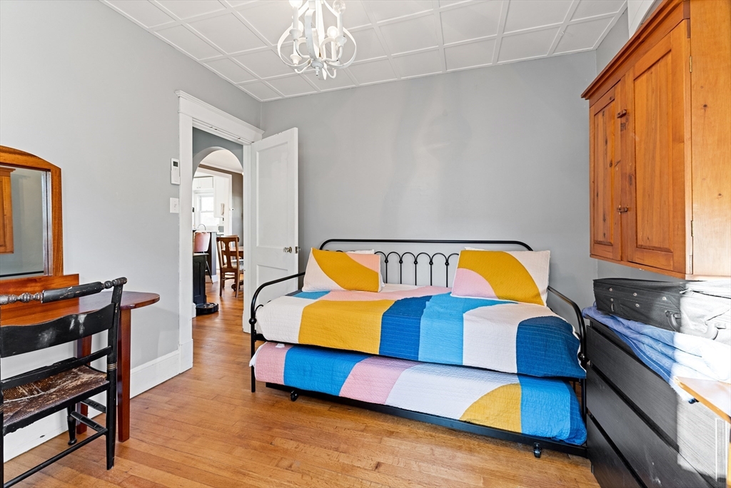 39 Catherine Street Pittsfield, MA 01201 - Photo 25 of 36 a living room with furniture and a chandelier