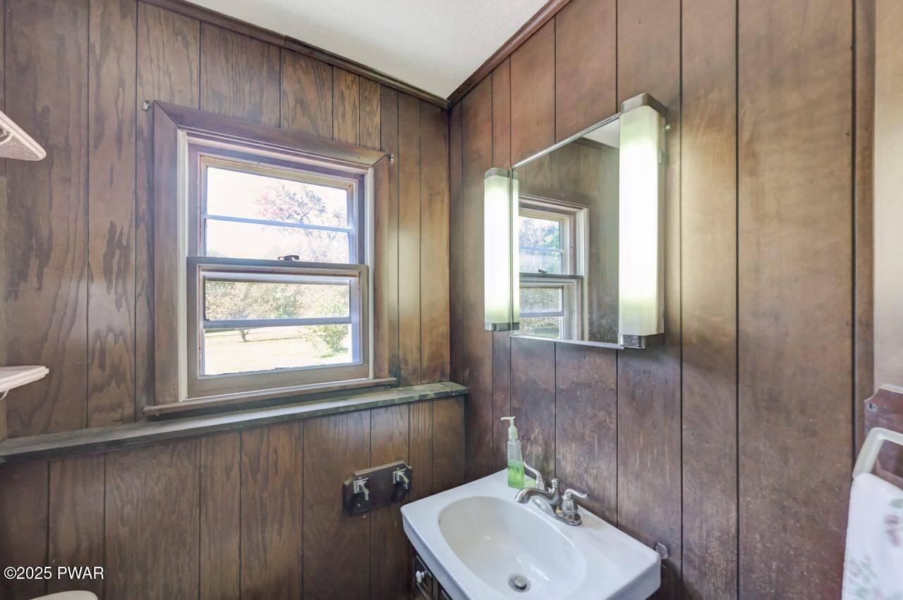 100 Spring Hill Road Moscow, PA 18444 - Photo 53 of 101 a bathroom with a sink a window and a toilet