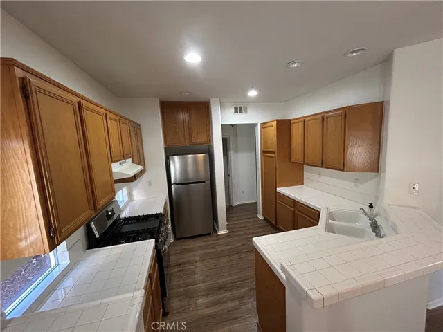 a kitchen with a refrigerator sink and stove