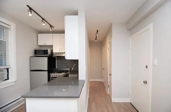 a kitchen with stainless steel appliances a sink stove and refrigerator