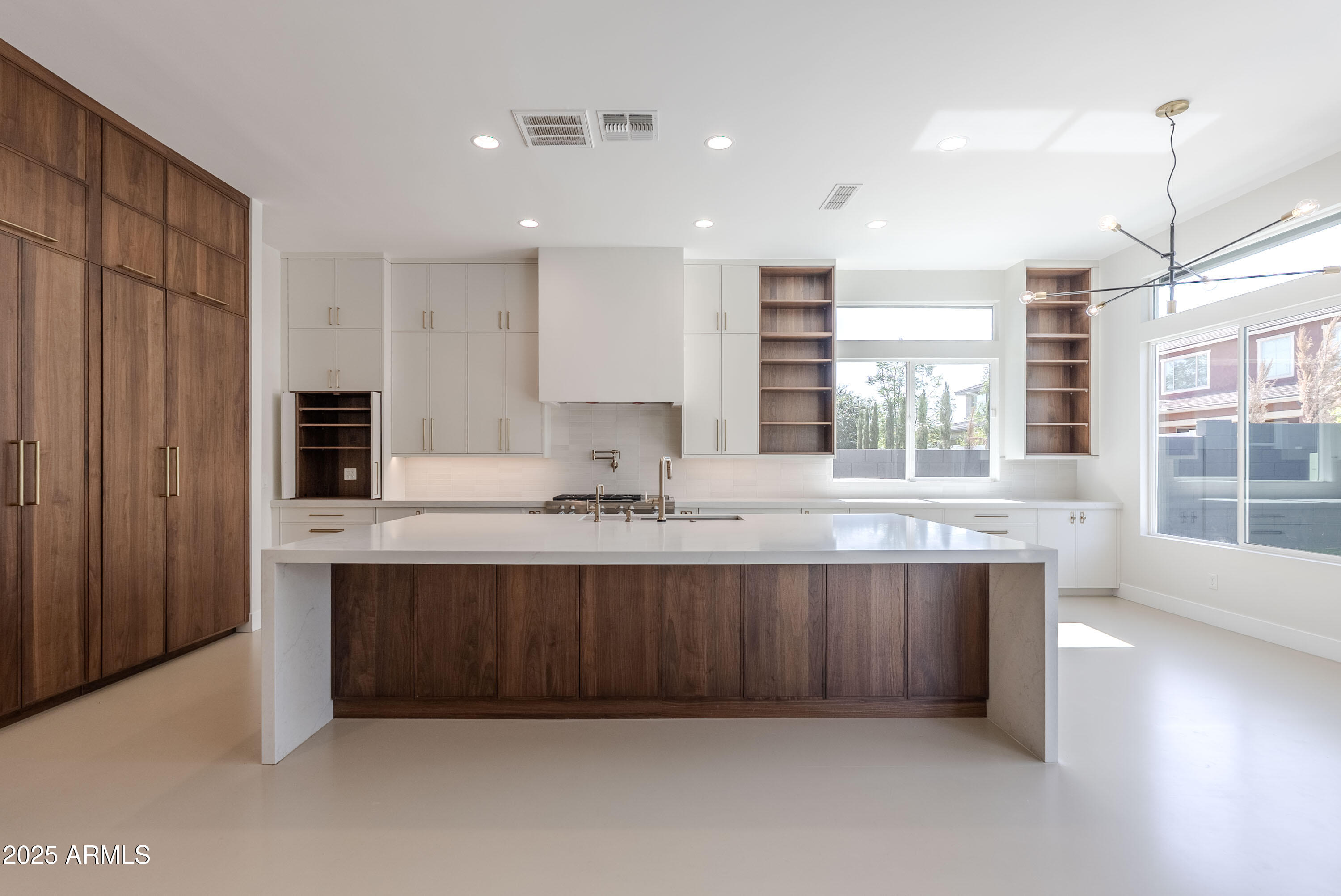 a large kitchen with granite countertop a sink and dishwasher a oven with wooden cabinets