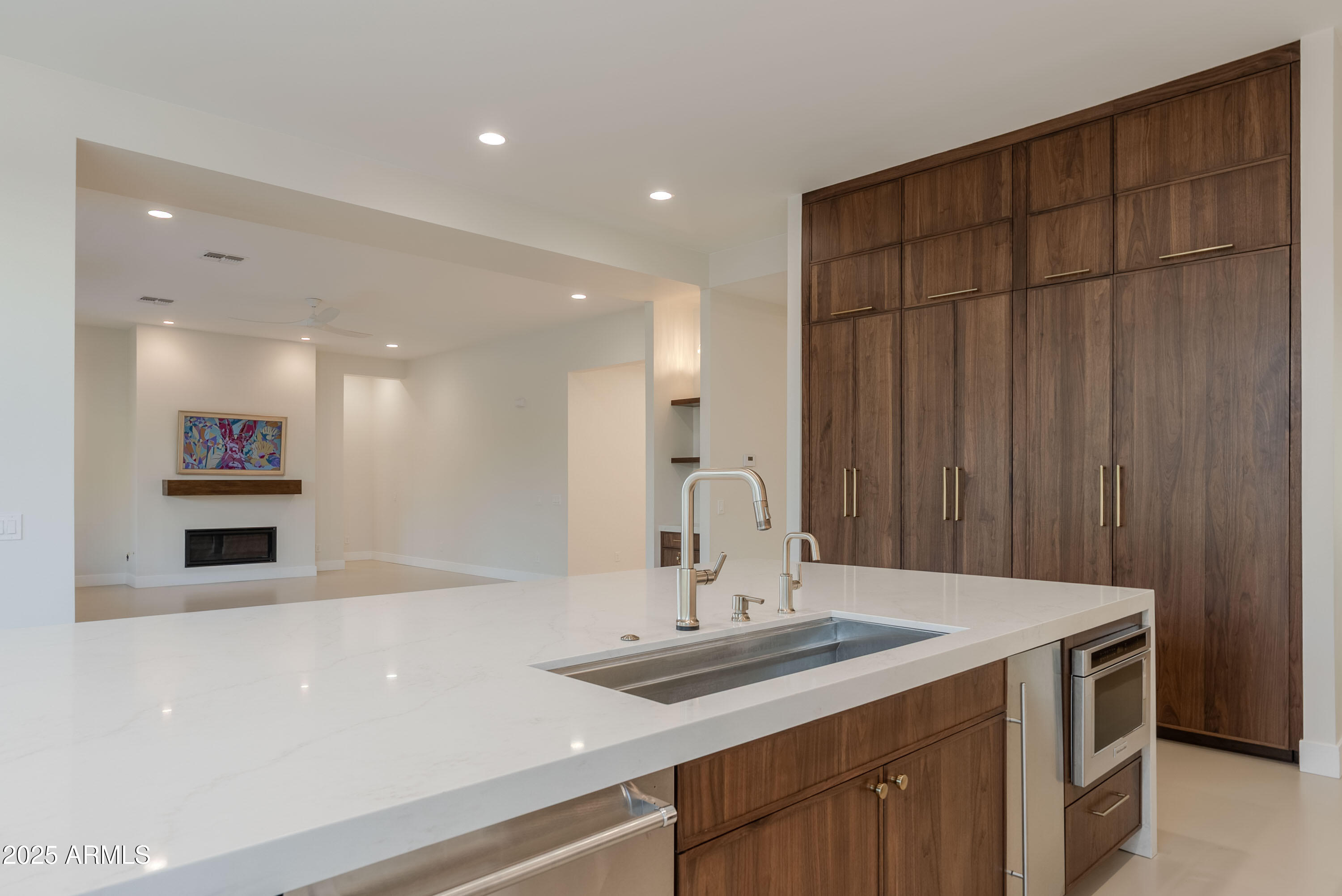 3145 East Boot Track Trail Gilbert, AZ 85296 - Photo 12 of 17 a kitchen with a sink and a refrigerator