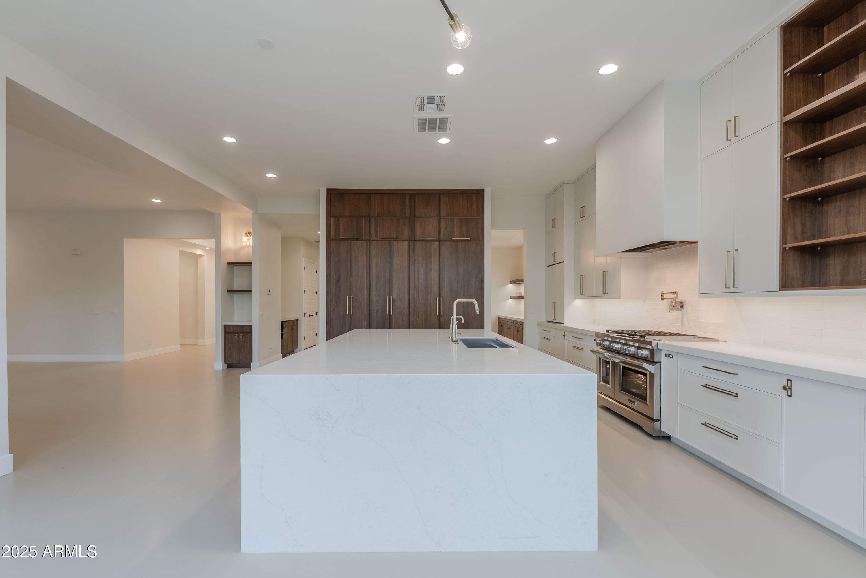 3145 East Boot Track Trail Gilbert, AZ 85296 - Photo 14 of 17 a large kitchen with stainless steel appliances kitchen island granite countertop a stove a sink and a refrigerator