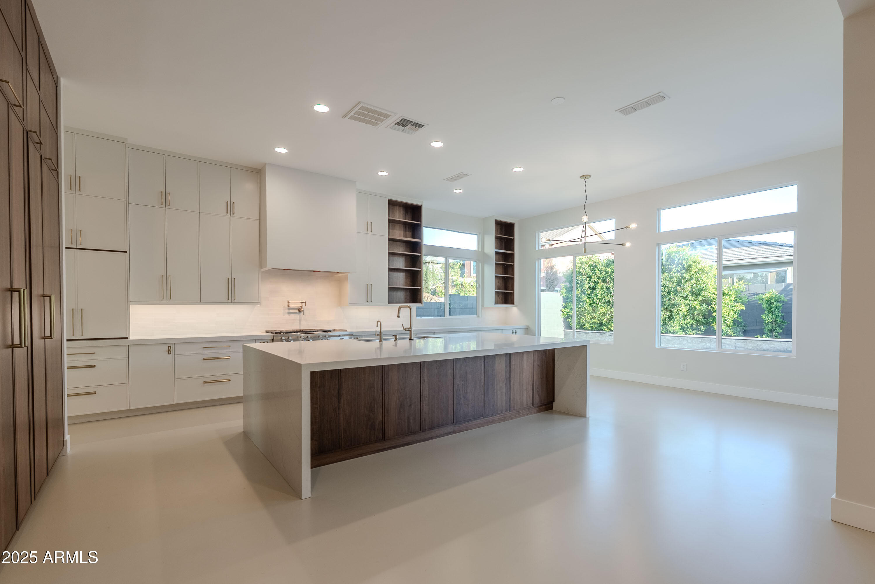 3145 East Boot Track Trail Gilbert, AZ 85296 - Photo 15 of 17 a large kitchen with kitchen island a sink stainless steel appliances and cabinets
