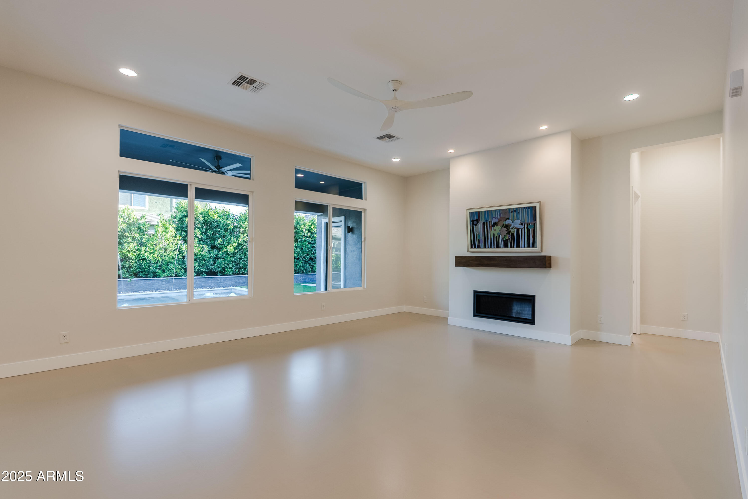 3145 East Boot Track Trail Gilbert, AZ 85296 - Photo 16 of 17 a view of empty room with wooden floor and fan