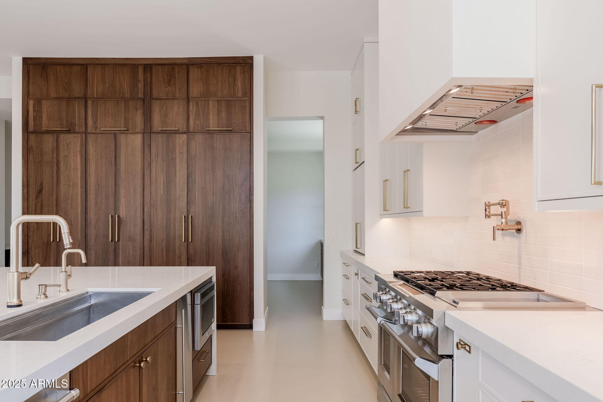 3145 East Boot Track Trail Gilbert, AZ 85296 - Photo 4 of 17 a kitchen with a stove and a sink