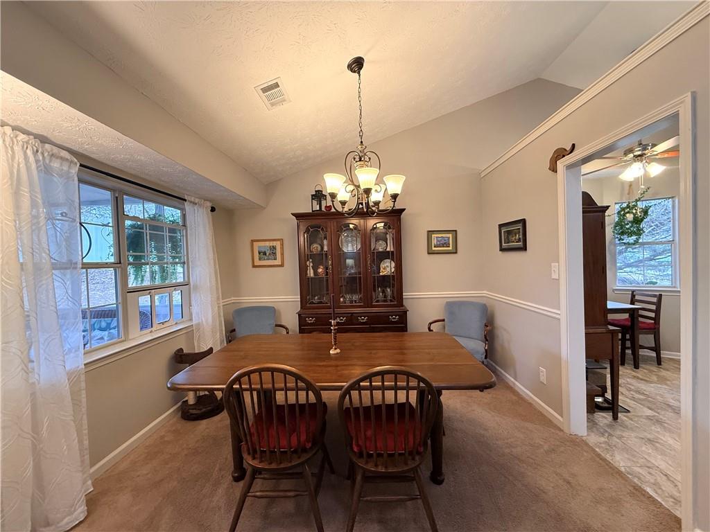3680 Hamilton Dam Road Dacula, GA 30019 - Photo 11 of 33 a view of a dining room with furniture window and outside view
