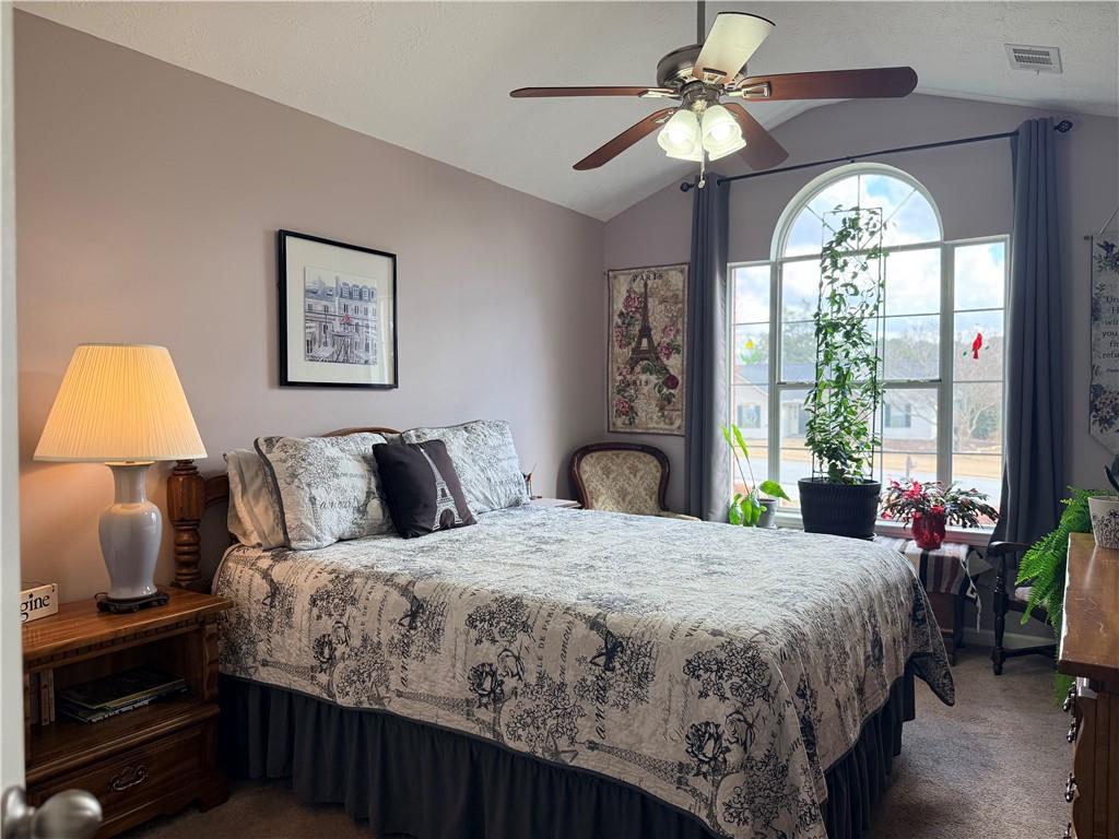 3680 Hamilton Dam Road Dacula, GA 30019 - Photo 12 of 33 a bedroom with a bed and a chandelier