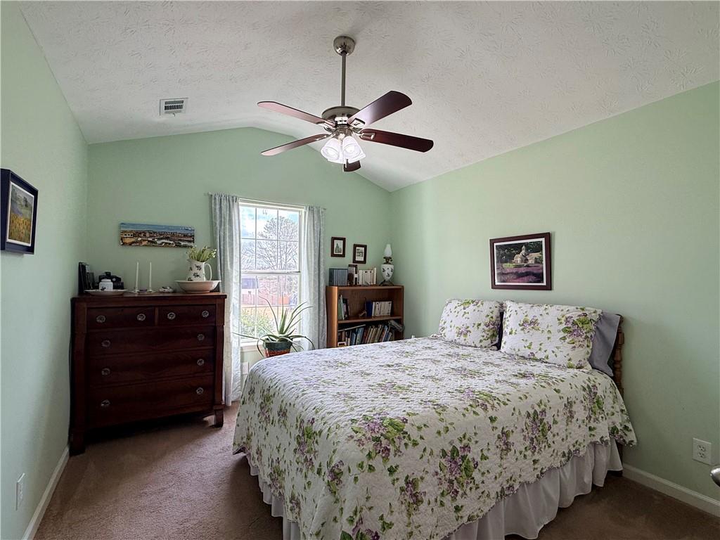 3680 Hamilton Dam Road Dacula, GA 30019 - Photo 13 of 33 a bedroom with a bed and a chandelier