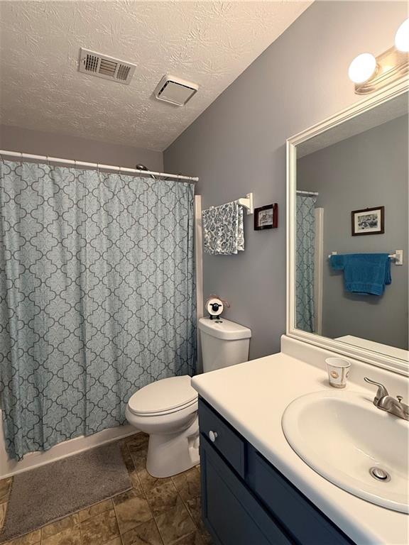 3680 Hamilton Dam Road Dacula, GA 30019 - Photo 14 of 33 a bathroom with a sink a toilet and shower
