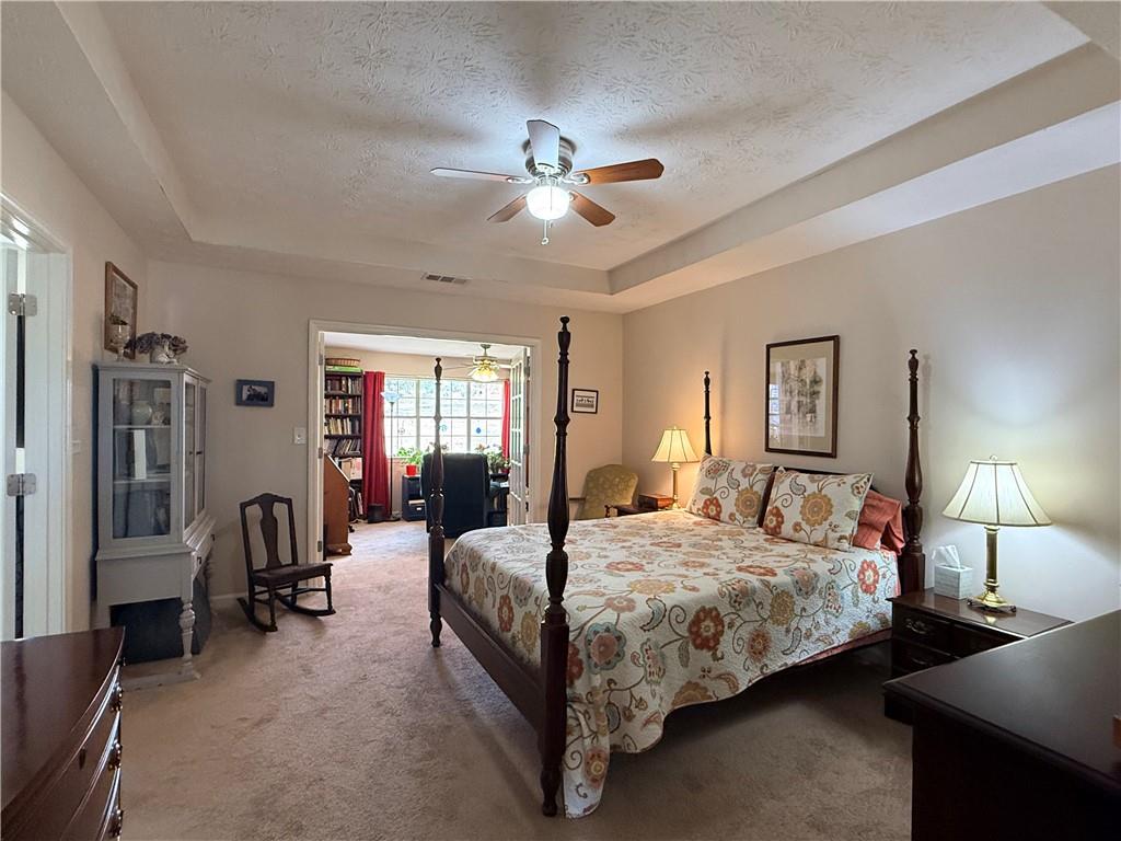 3680 Hamilton Dam Road Dacula, GA 30019 - Photo 15 of 33 a bedroom with bed and a chandelier