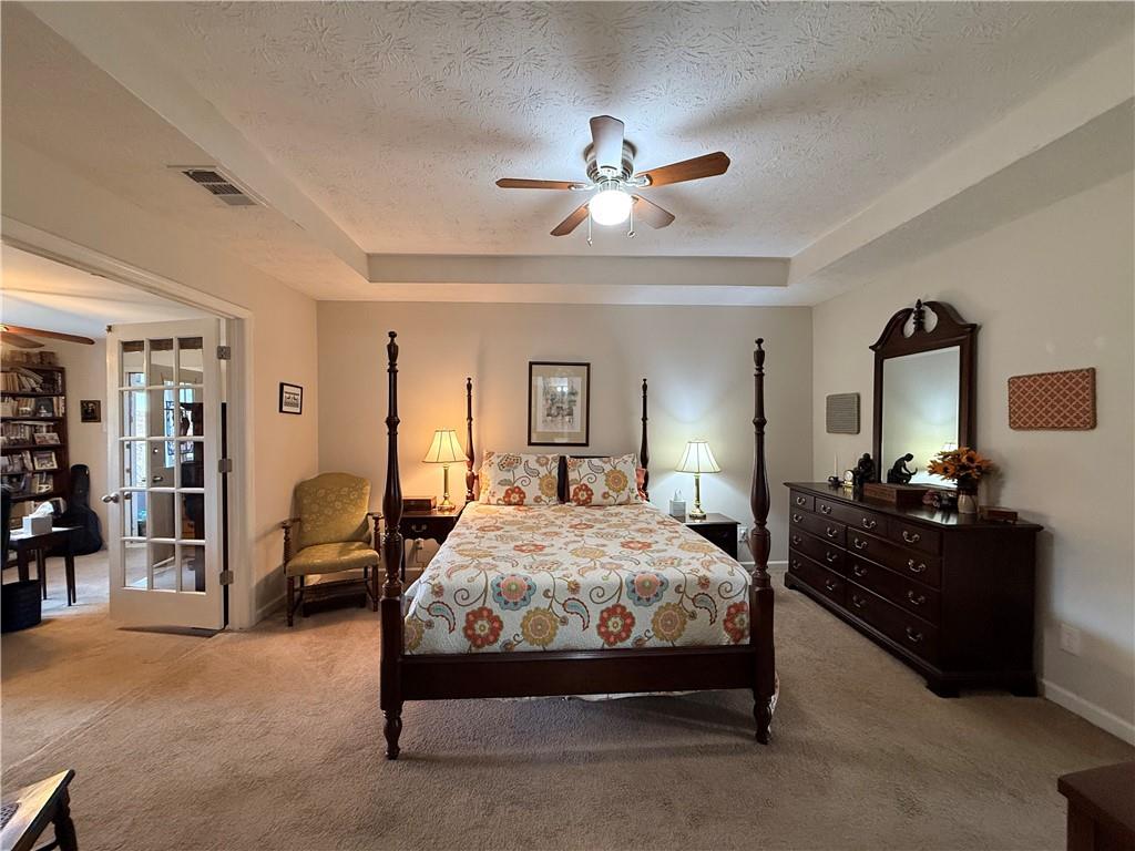 3680 Hamilton Dam Road Dacula, GA 30019 - Photo 16 of 33 a bedroom with a bed and ceiling fan